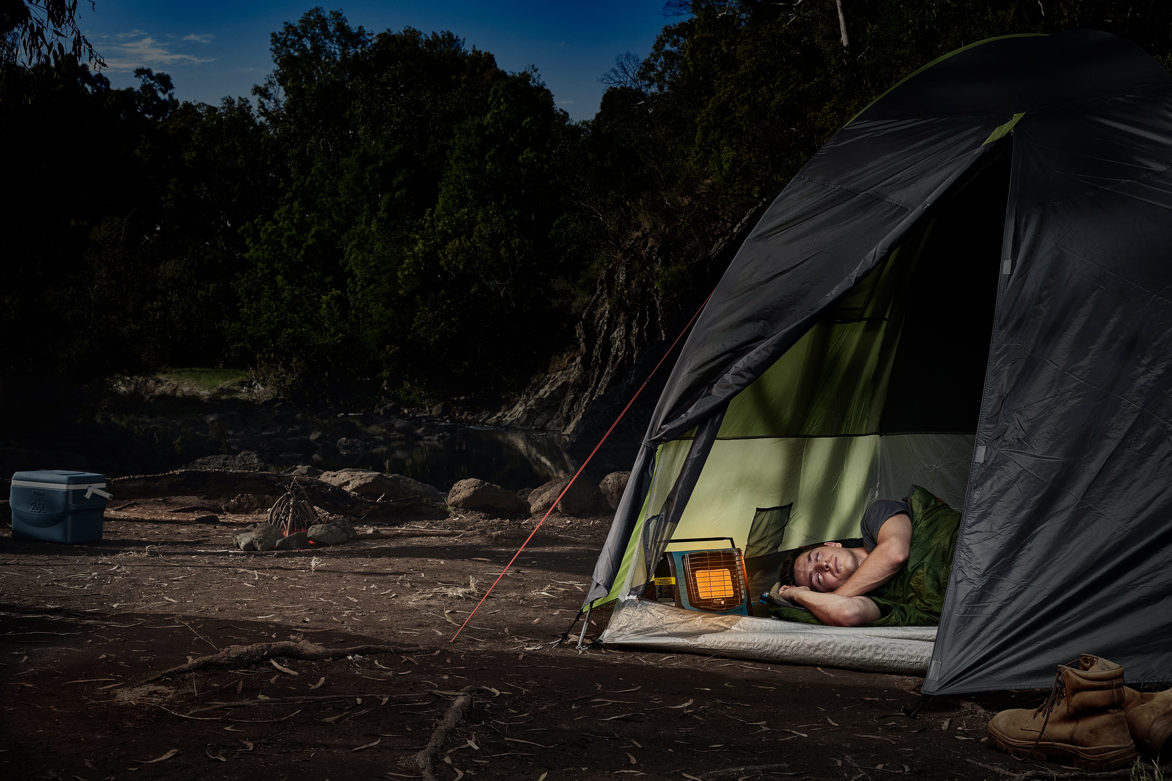 Young man sleeping in a tent