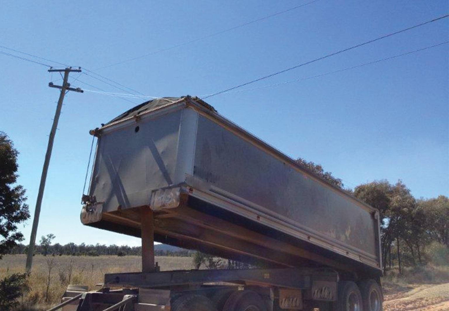 Tipper truck near powerline