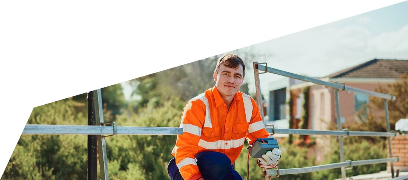 Image of an A Grade electrician servicing solar on a roof