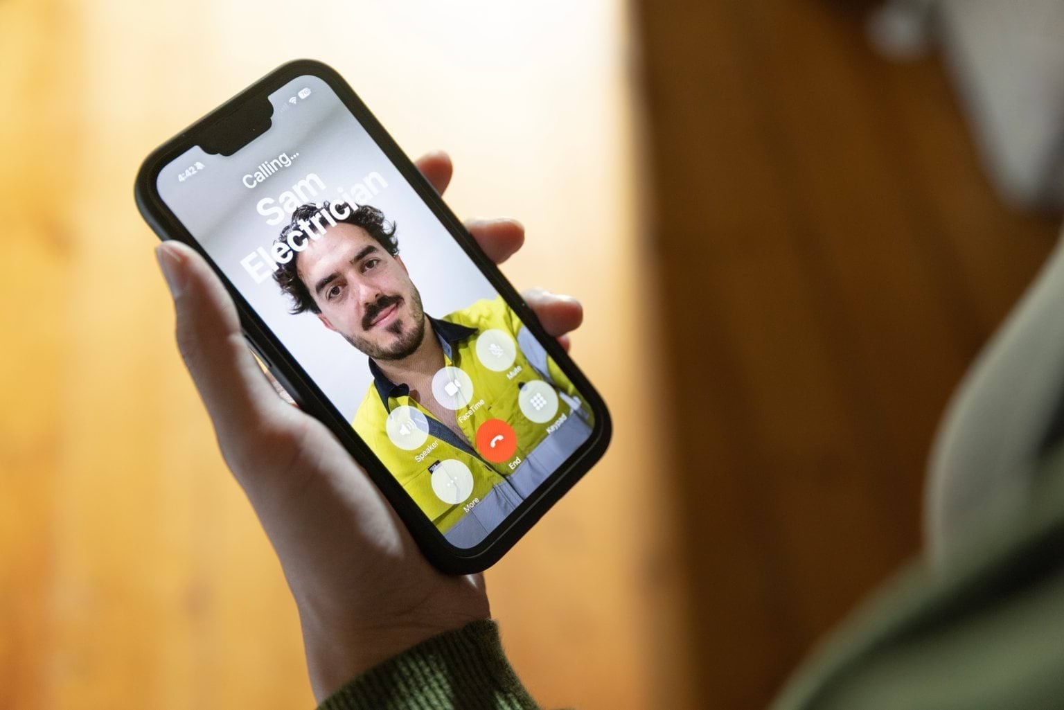 Woman calling a licensed electrician on an iPhone