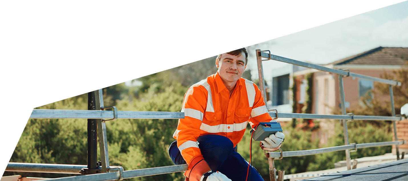 Electrician on a roof servicing solar panels